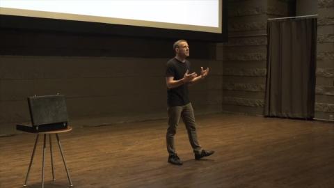 David speaking on a stage